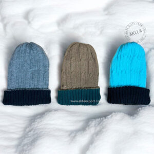 Group of three reversible alpaca hats in different colors, featuring fisherman knit beanie style.