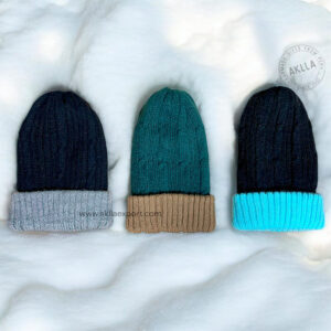 Group of three reversible alpaca hats in different colors, featuring fisherman knit beanie style.