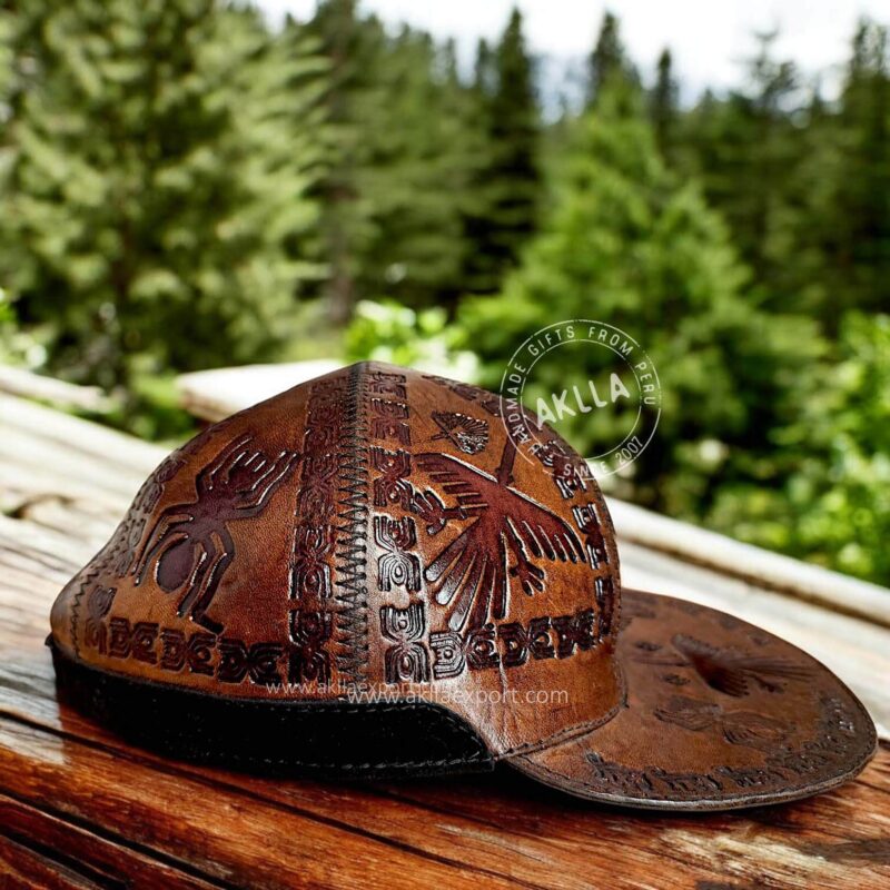 Handmade embossed leather cap with Peruvian iconography and Andean fabric.