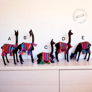 Handcrafted llama figurine and wooden vicuña carved from mohena wood with colorful Andean textile mantle