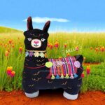 Handmade embroidered llama pillows with Peruvian striped fabric, floral collars, tassels, and stitched fleece details