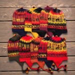 Pack of 10 handmade alpaca wool chullos in rasta colors from Peru