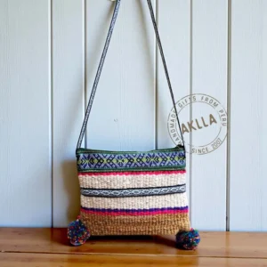 Genuine sheep wool purses from Peru with woven strap extended upward.