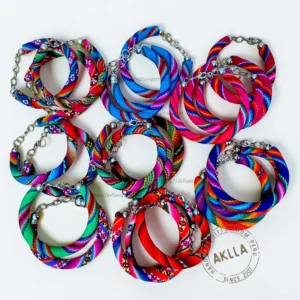 Pack of 25 colorful fabric bracelets handmade in Peru with woven Andean textile patterns and adjustable clasp