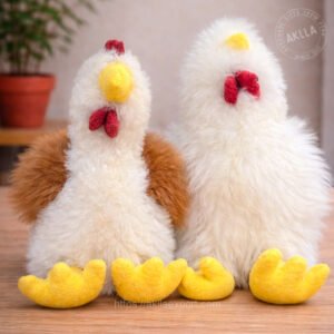 Two handmade alpaca plush chickens in white fiber standing together on wooden surface showing size comparison
