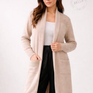 Woman wearing long alpaca sweater cardigan in beige with shawl collar ribbed details and front pockets