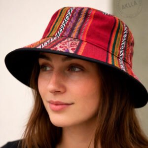 Woman wearing handmade Andean wool bucket hat close-up showing bold geometric pattern and black brim trim